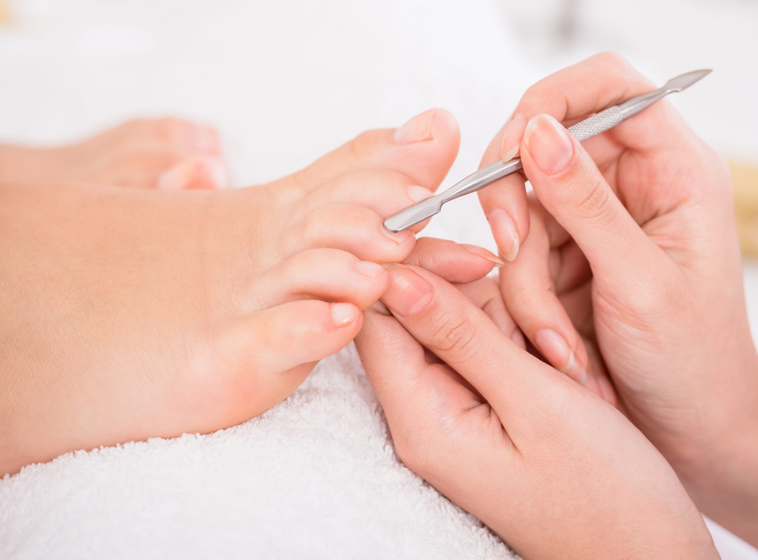 Careful pedicure work at Popular Nails
